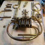 French horn disassembled to get access to bent tubing. This was required to reattach tube to valve block.