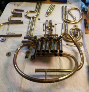 French horn disassembled to get access to bent tubing. This was required to reattach tube to valve block.